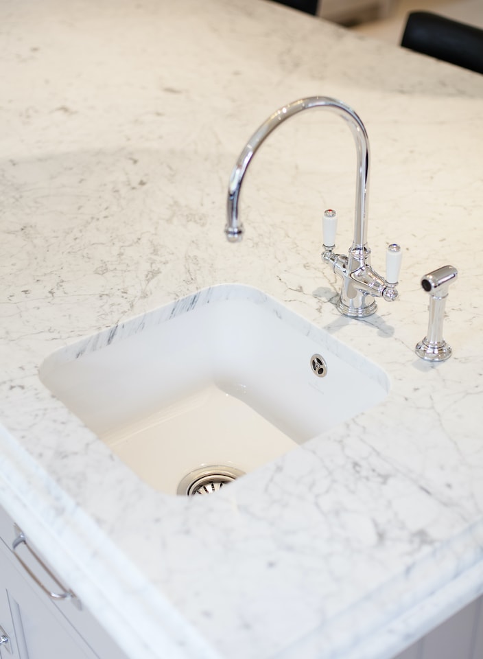 fitted basin and taps in marble worktop