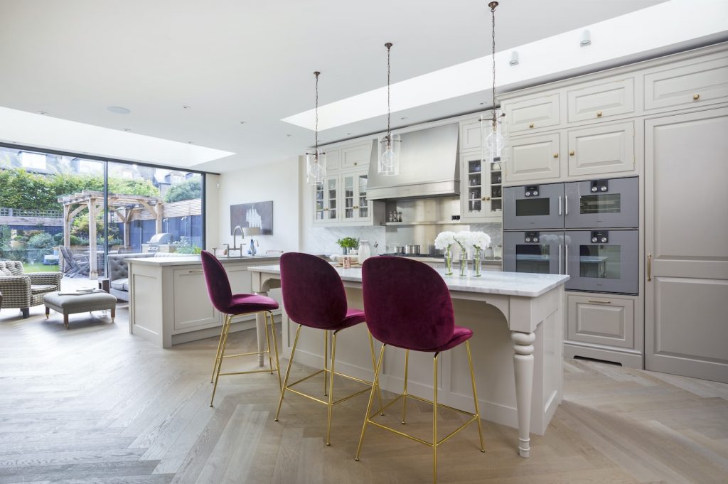 contemporary luxury kitchen with striking purple and gold feature bar stools